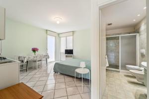 a bedroom with a bed and a bathroom at Green Village Accommodations in Colico +37 photos