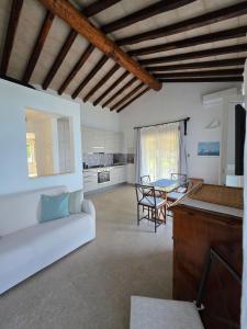 a living room with a white couch and a table at Blue Eden La Maddalena in La Maddalena
