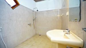 a bathroom with a sink and a shower at Jungle Nature Villa in Sigiriya