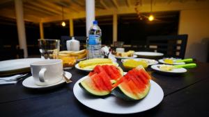 a table with two slices of watermelon on a plate at Jungle Nature Villa in Sigiriya +54 photos