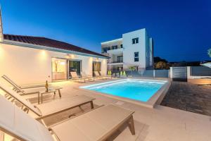 a swimming pool in the backyard of a house at Villa Ballat with heated pool in Privlaka