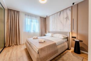 a bedroom with a bed and a large window at Villa Ballat with heated pool in Privlaka +33 photos