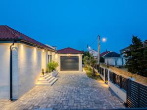 a garage in a house with a driveway at Villa Ballat with heated pool in Privlaka