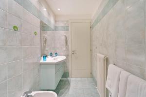 a bathroom with a sink and a toilet at Green Village Accommodations in Colico