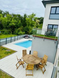 a patio with a table and chairs and a pool at We-Home in Wetzlar