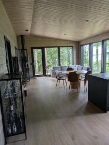 a living room with a couch and a table and chairs at Villa Anttoora in Pori