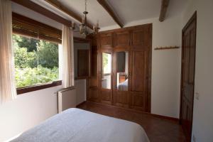 1 dormitorio con cama y ventana grande en Casa Loles, en Capileira