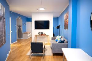 a living room with blue walls and a couch and a table at Scandic Vulkan in Oslo