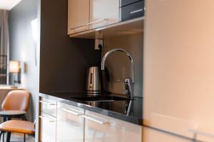 a kitchen with a sink and a counter top at Scandic Vulkan in Oslo