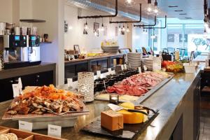 a buffet line with many different types of food at Scandic Vulkan in Oslo
