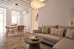 a living room with a couch and a table at Kaitlyn's Residence in Mikonos
