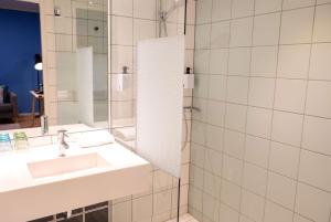 a bathroom with a sink and a mirror at Scandic Vulkan in Oslo