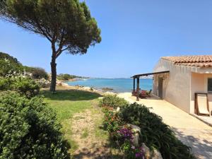 a house with a view of the ocean at Blue Eden La Maddalena in La Maddalena