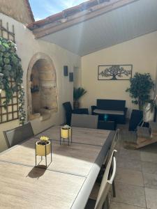 a room with a large table and chairs and a piano at Maison de la Combe in Domme