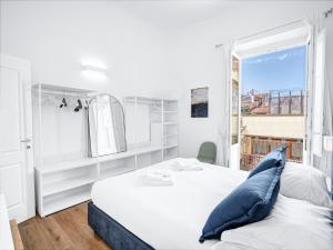 a white bedroom with a large bed and a window at Four Seasons Martelli Luxury Apartment 50 m from Duomo in Florence