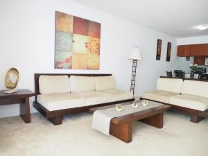 a living room with two couches and a coffee table at Emerald2 Room at Brighton Beach 2Min Walk to Ocean & Subway Chic Stay in Brooklyn