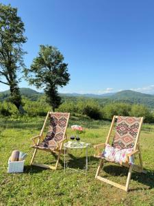 two chairs and a table in a field at Windy Hills in Noga