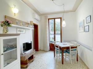 a dining room with a table and a television at La Loggia near Piazza del Campo in Siena