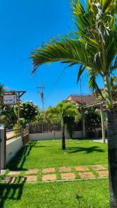 eine Palme in einem Garten neben einem Zaun in der Unterkunft Casa Maré Beach em Caetanos Ceará in Amontada + 41 Fotos