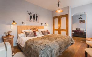 a bedroom with a large bed in a room at Hôtel du Lion d'Or in Cauterets