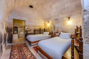 Postel nebo postele na pokoji v ubytování MDC Cave Hotel