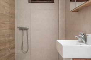 a bathroom with a sink and a shower at SeaView Apartment 4 in Psilí Ámmos +50 photos