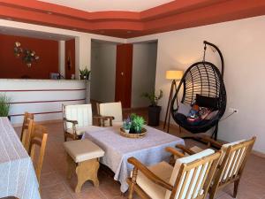 a dining room with a table and chairs and aoit at Hotel Aki in Loutra Edipsou