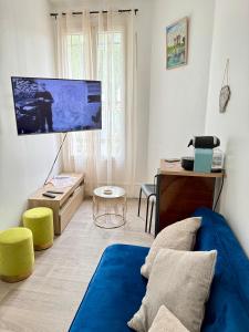 a living room with a large flat screen tv at Balcon de Paris in Gennevilliers +20 photos