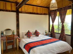 a bedroom with a bed and a table with a mirror at The Link farmstay in Sa Pả +153 photos