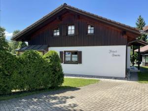 a house with a brown and white building at Ferienhaus Untere Gamssteige im Feriendorf Reichenbach UG2 in Nesselwang