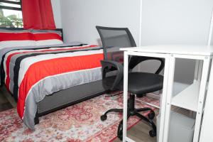 a bedroom with a bed and a desk and a chair at Ruby2 Room at Brighton Beach 2Min Walk to Ocean & Subway Chic Stay in Brooklyn