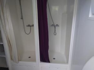 a bathroom with a shower and a mirror at MacDonald Cabins in Kinlochleven +30 photos