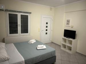 a bedroom with a bed with two towels on it at Emerald Studio in Límni