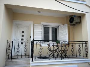 a balcony with a black railing and a window at Emerald Studio in Límni