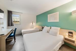 Voodi või voodid majutusasutuse Comfort Hotel Orleans Saran toas