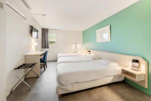 Voodi või voodid majutusasutuse Comfort Hotel Orleans Saran toas