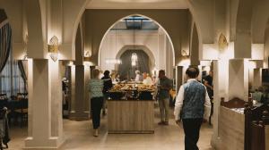 a group of people walking around a buffet in a building at RS Hotel Karam Palace in Ouarzazate