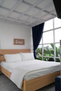 a bedroom with a bed and a large window at SIP Garden Villa in Cibeuteung Udik +3 photos