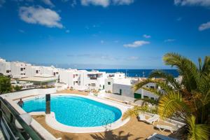 vistas a la piscina desde el balcón de un complejo en Lanzholidays, en Tías