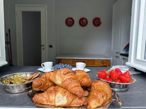 a table with several croissants and fruit on it at Lakе Maggiorе Gеm Landana in Intra