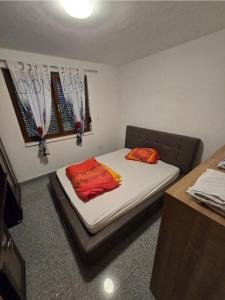 a bed in a room with a bed sidx sidx sidx sidx at Stan na Dan Cazin in Ivišovo Greblje