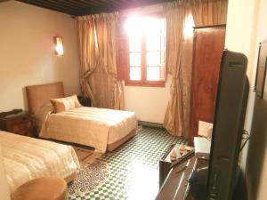 Postel nebo postele na pokoji v ubytování Riad-Boutique Borj Dhab Fez