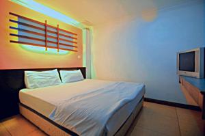 Ein Bett oder Betten in einem Zimmer der Unterkunft Hotel China Town 2
