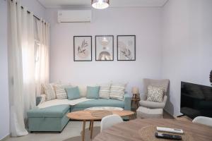 a living room with a couch and a table at Olia's House in Skala Eresou