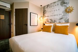 Postel nebo postele na pokoji v ubytování Hotel Laperouse