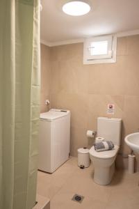 a bathroom with a toilet and a sink at Olia's House in Skala Eresou