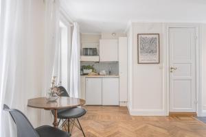 a kitchen and dining room with a table and chairs at Apartment in Old Town in Stockholm +10 photos