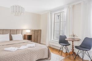 a bedroom with a bed and two chairs and a table at Apartment in Old Town in Stockholm