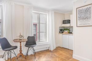 a living room with two chairs and a table at Apartment in Old Town in Stockholm
