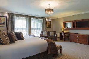 a hotel room with a large bed and a desk at Westport Woods Hotel & Spa in Westport +26 photos